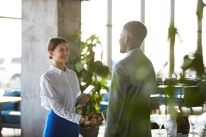 woman shaking hands with man