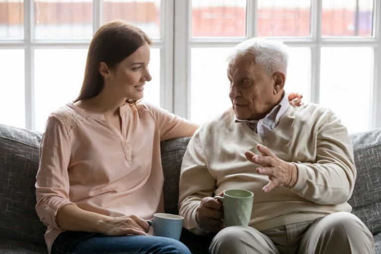 A senior man having a difficult conversation with his child about when to stop driving in older age.
