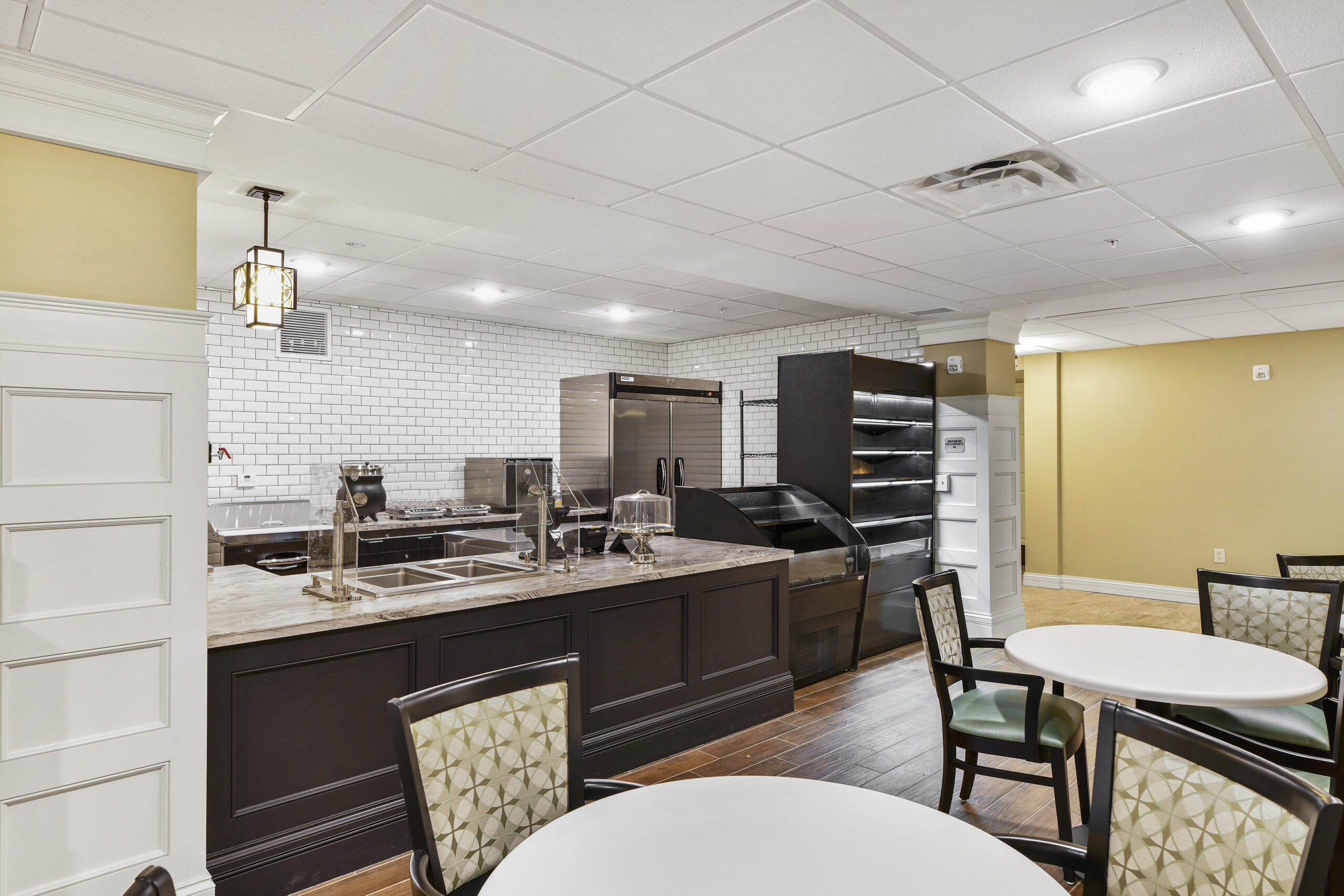 Interior of a dining area with tables and a food service counter