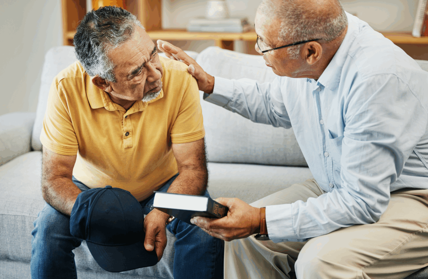 Chaplain comforting a distressed senior man