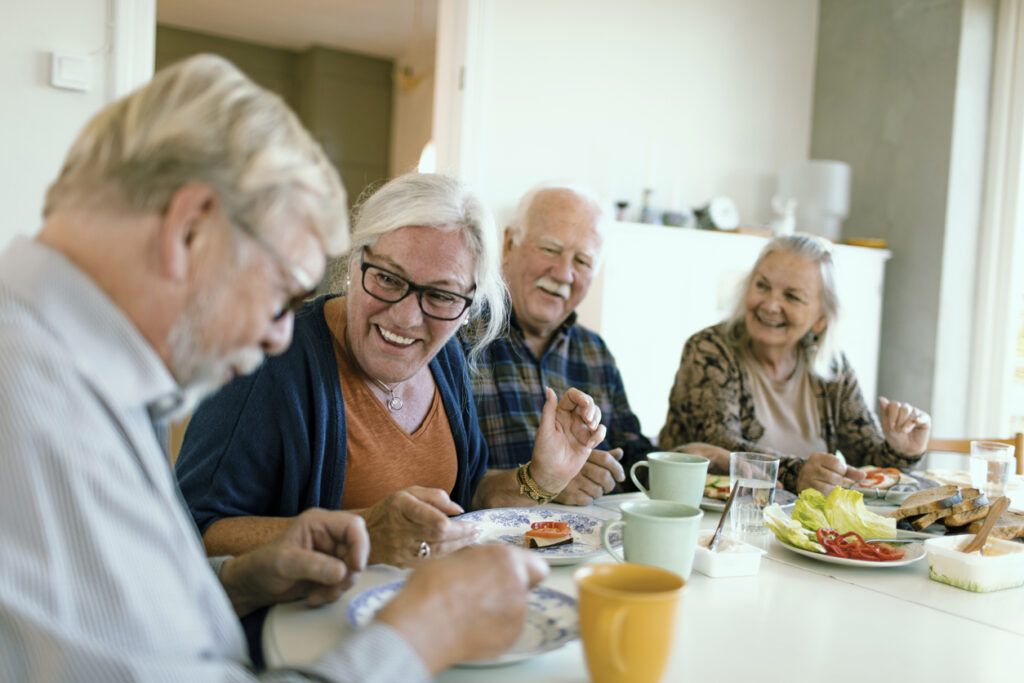 Seniors enjoying a meal together at a table