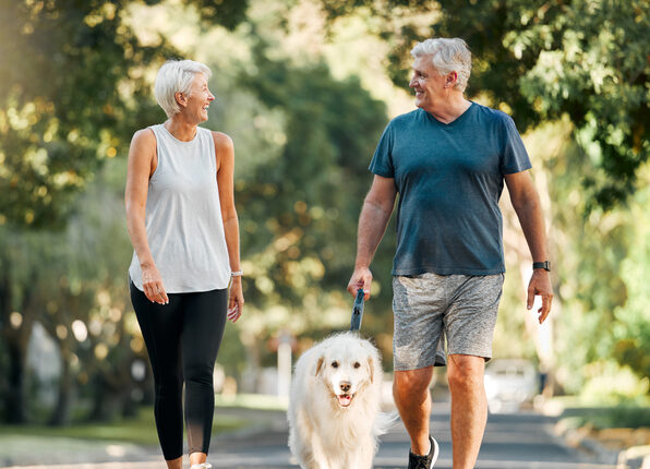Senior couple walking dog