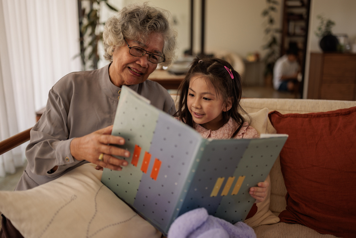 Senior reading to girl