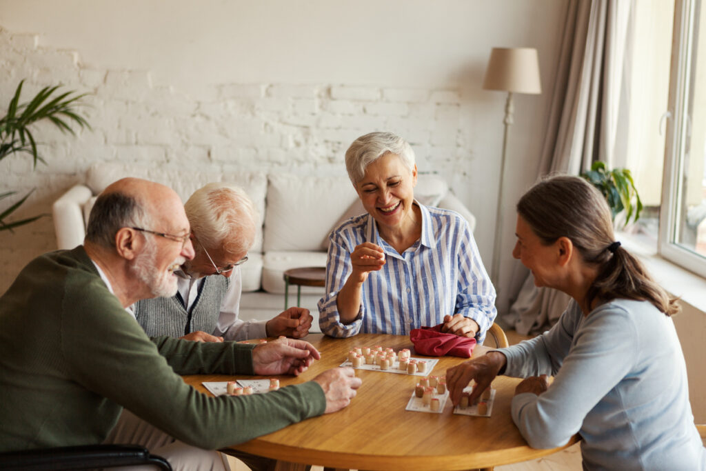Assisted living residents playing in a lounge area