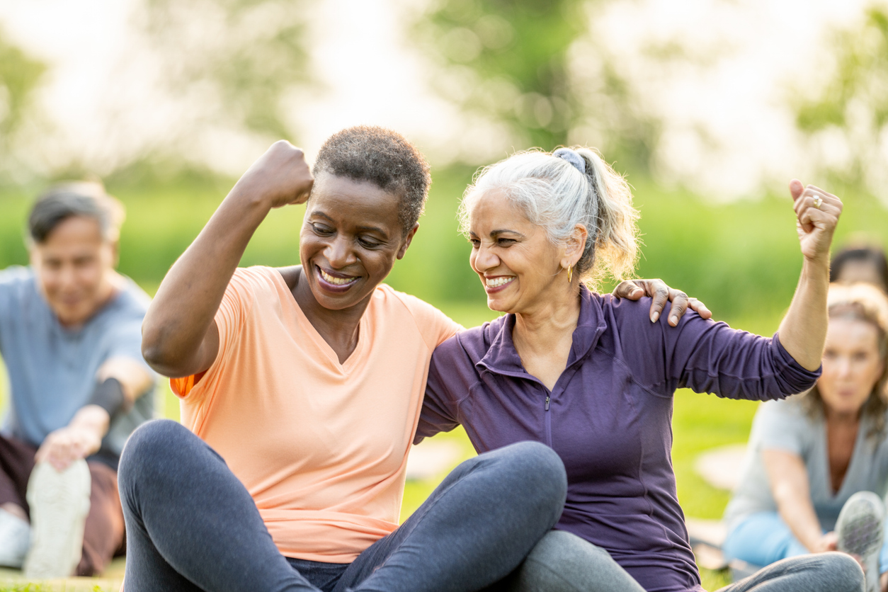 Two senior women celebrating after yoga