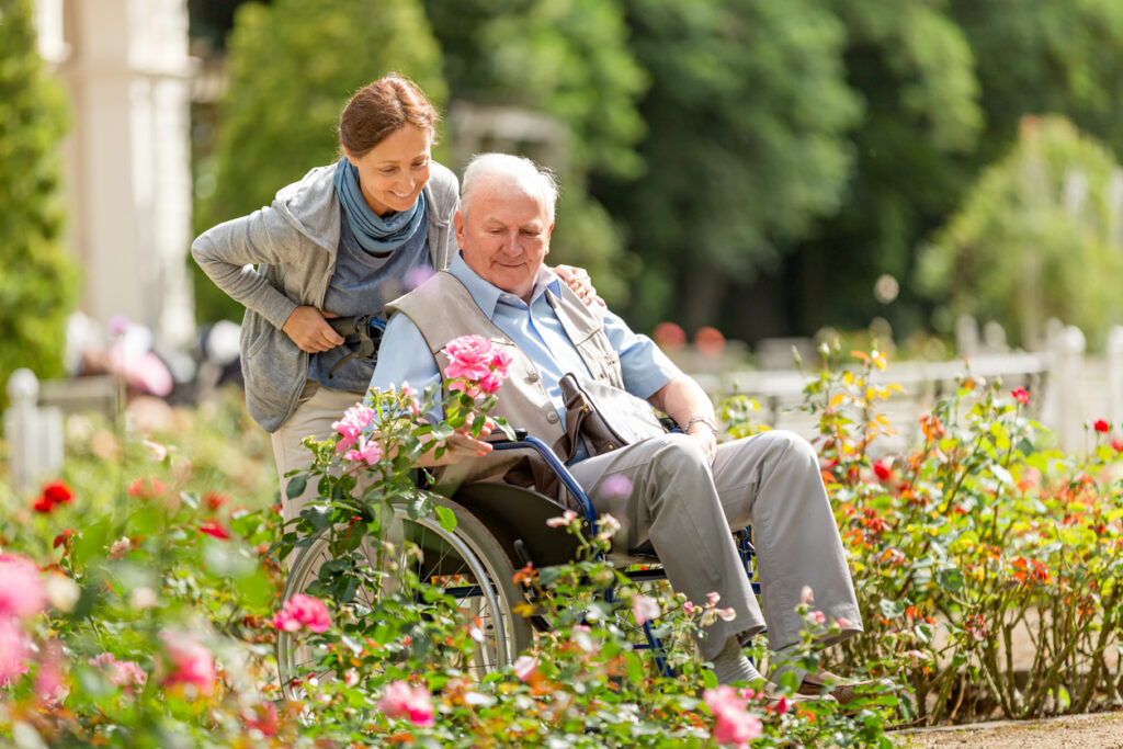 Caregiver and senior man on wheel chair