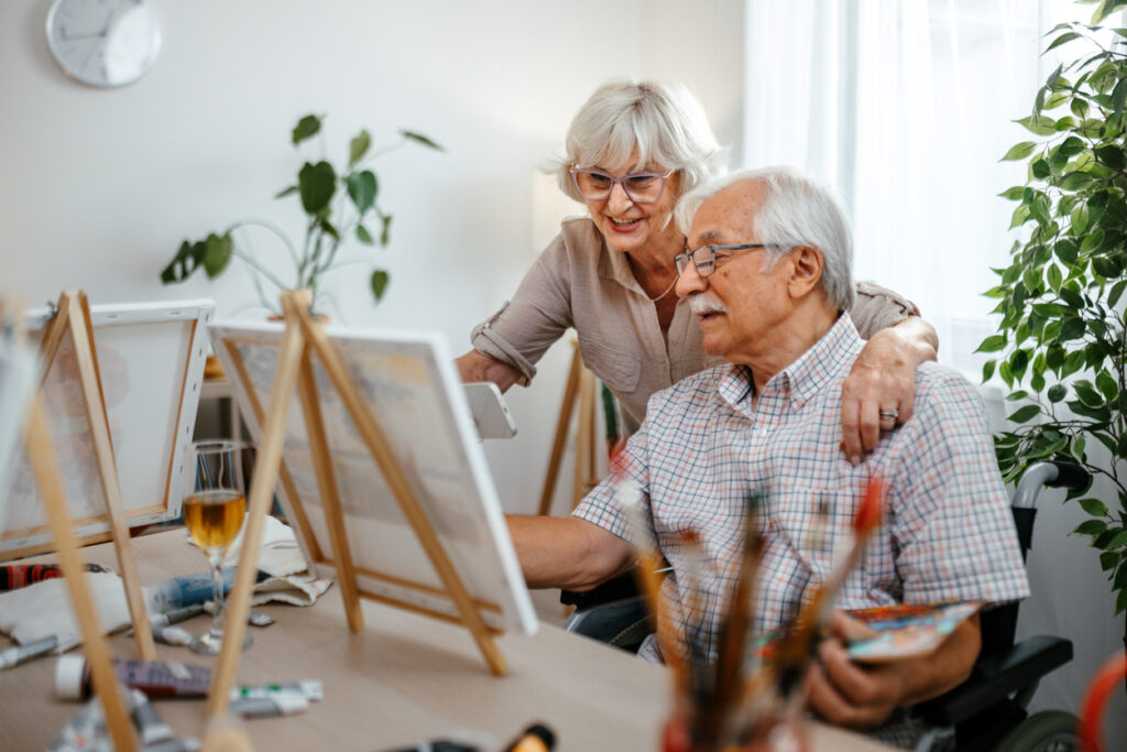 Senior couple painting together at home