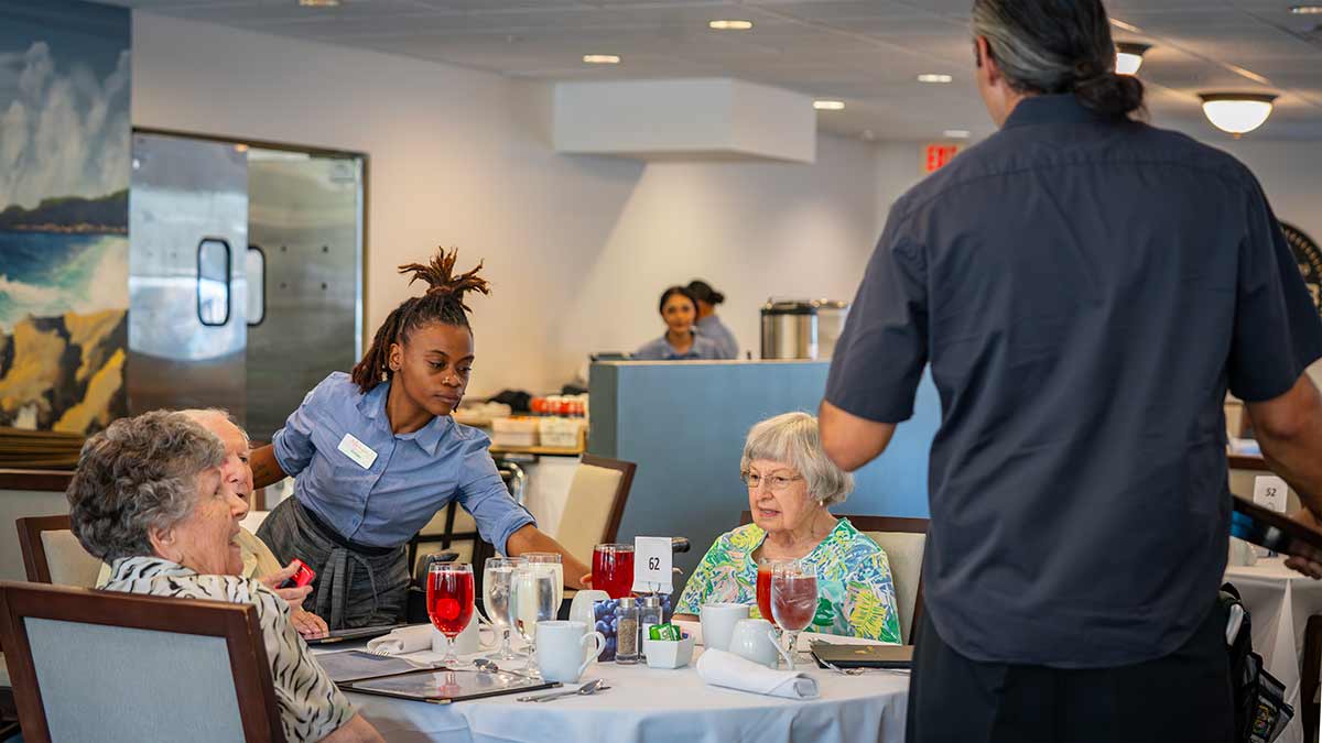 Seniors being served dinner